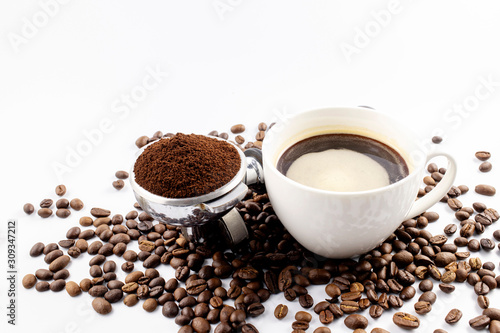 Coffee cop and brown roasted coffee beans and coffee powder on the potta filter isolated on white background.