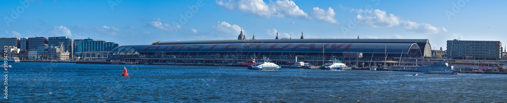 panoramic view of central station in amsterdam from side of the water, cityscape panoramic view of central station in amsterdam from side of the water, cityscape