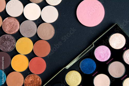Make-up colorful eye shadow palettes isolated on black background. 
