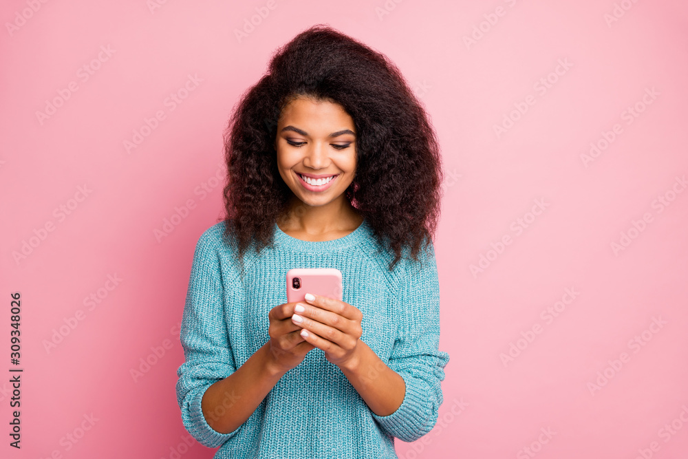 Photo of cheerful positive cute pretty sweet girl smiling toothily beaming browsing through telephone isolated pastel color background Photo of cheerful positive cute pretty sweet girl smiling toothily beaming browsing through telephone isolated pastel color background
