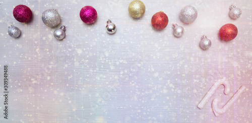 Christmas card with colorful baubles and sugar canes. 