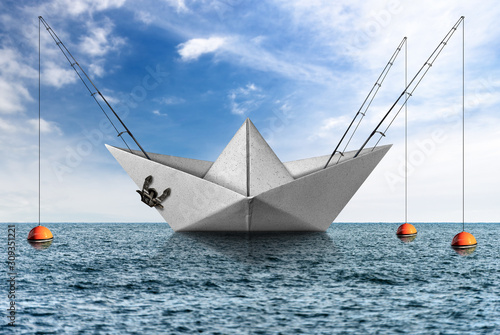 White paper boat with fishing rods in the sea with blue sky and clouds, big game fishing concept, photography