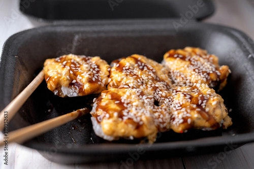 warm sushi in package. sushi with eel in unagi sauce. selective focus