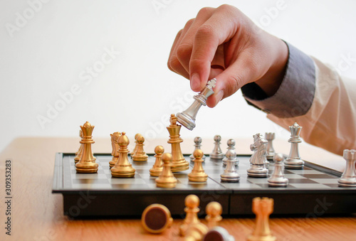 The silver chess king's hand is about to win,The golden King chess is losing.business concept, we are going to win competitors, better marketing, business can grow better.