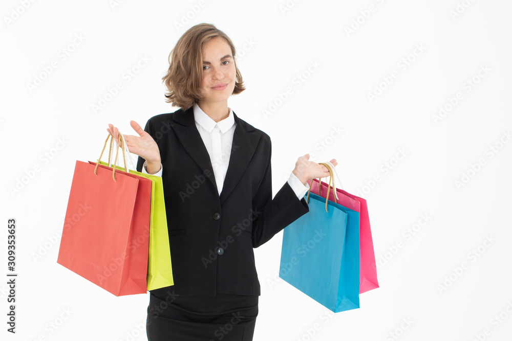 Portrait of young business woman holding shopping bags on white isolated background.