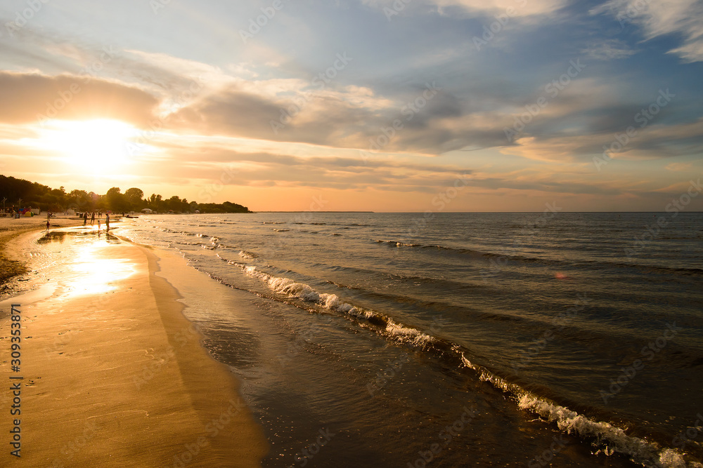 Colourful sunset on the beach of the Baltic sea in Jurmala, Latvia. Summer evening