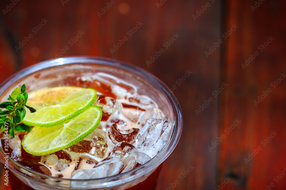 Glass with ice tea lemon on the table. Glass with ice tea lemon on the table.