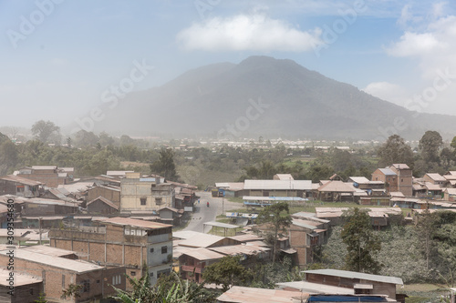 Beautiful cityscape of Berastagi, Sumatra, with a volcanic ash covered landscape by volcano Mount Sinabung