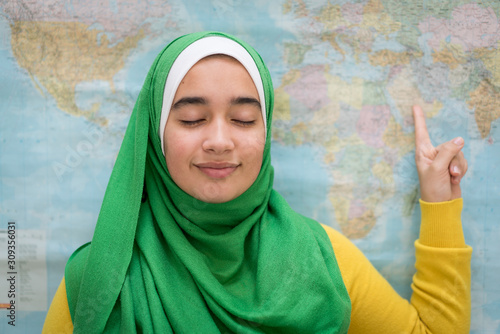 Muslim girl with world map photo