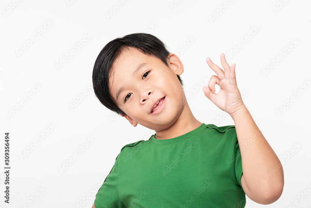 Portrait of little school boy showing OK gesture Portrait of little school boy showing OK gesture