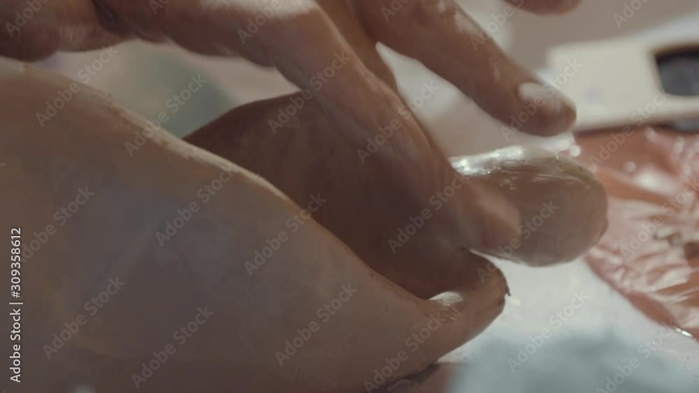 close-up to the hands of a sculpture artist while creating the curves close-up to the hands of a sculpture artist while creating the curves