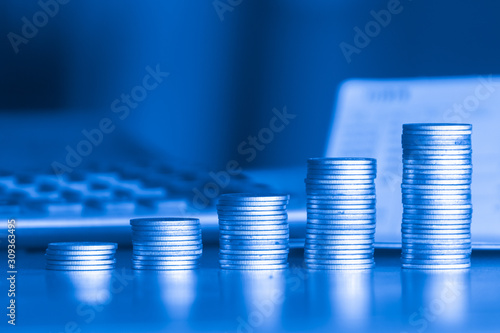 stacks of money coin background concept saving money with blue filter