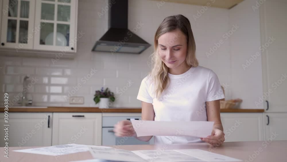 Portrait of woman working with papers at kitchen Portrait of woman working with papers at kitchen