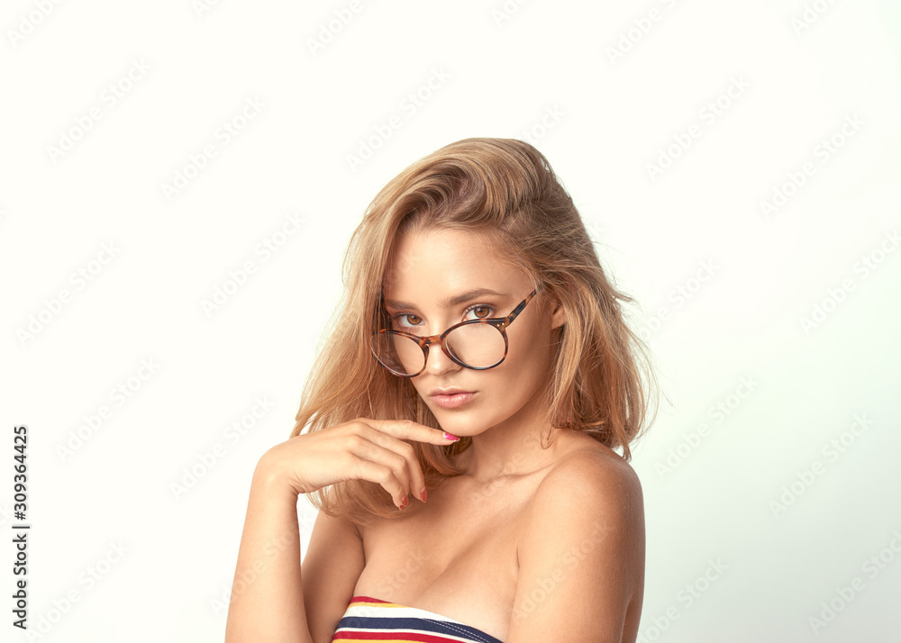 young girl in glasses, beautiful and healthy skin, natural blond hair, empty background, delicate makeup young girl in glasses, beautiful and healthy skin, natural blond hair, empty background, delicate makeup