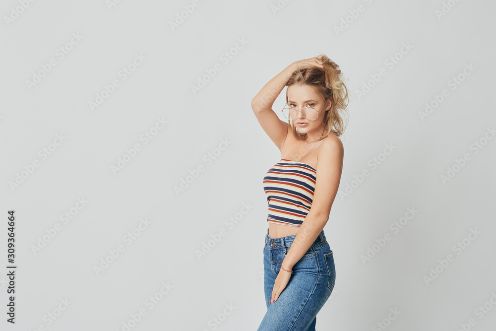 young girl in glasses, beautiful and healthy skin, natural blond hair, empty background, delicate makeup young girl in glasses, beautiful and healthy skin, natural blond hair, empty background, delicate makeup
