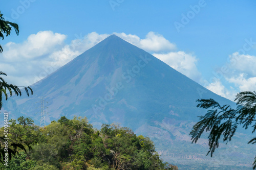 A distant view on Volcano Inierie, Bajawa, Indonesia. The pyramid like mountain towers above the landline. There are no other high volcanos around. The upper slopes are bare without any vegetation. photo