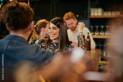 Photography Young handsome caucasian couple standing in bar, chatting and flirting and having great time