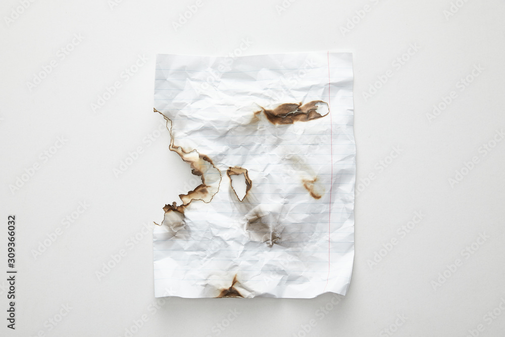 top view of empty crumpled and burnt vintage paper on white background