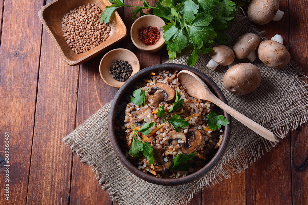 Buckwheat porridge with mushrooms in a bowl. Vegan , gluten-free. Russian or Ukranian cuisine. Healthy food concept Buckwheat porridge with mushrooms in a bowl. Vegan , gluten-free. Russian or Ukranian cuisine. Healthy food concept