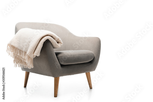 Fototapeta comfortable grey modern armchair with blanket isolated on white