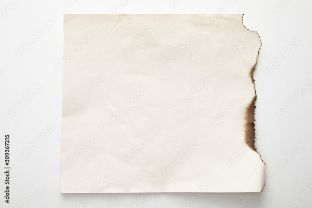 Obraz premium top view of empty burnt vintage paper on white background