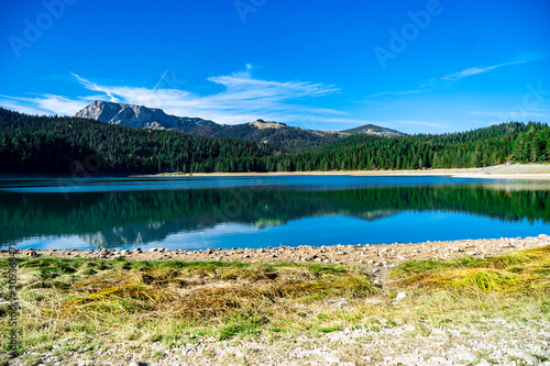 Lake in the middle of the mountain with rocky peaks away