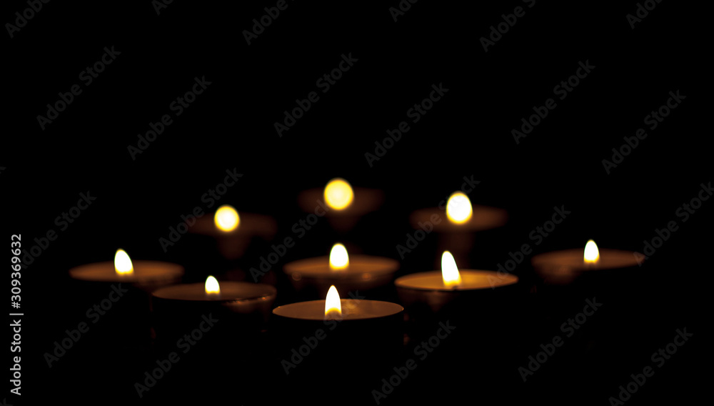 Burning candles in the dark in the form of a rhombus shape. Burning candles in the dark in the form of a rhombus shape.