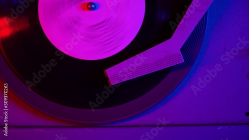 A record being played on a retro turntable that plays vinyl vintage records. Record players and turntables were popular in the 50s, 60s.Vintage Retro vinyl LP 