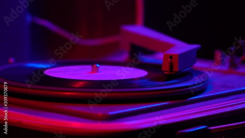 Vintage Retro vinyl LP record turntable player with an record playing,close up.Vintage lighting