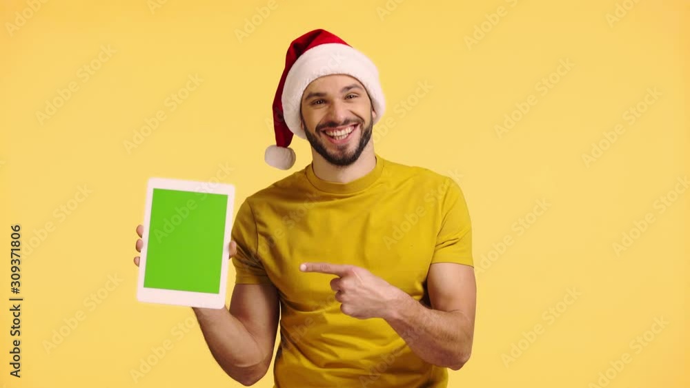 man pointing with finger at digital tablet isolated on yellow man pointing with finger at digital tablet isolated on yellow