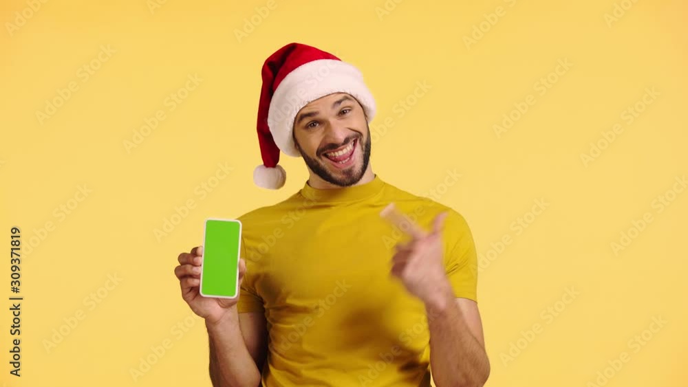 man pointing with finger at smartphone isolated on yellow man pointing with finger at smartphone isolated on yellow