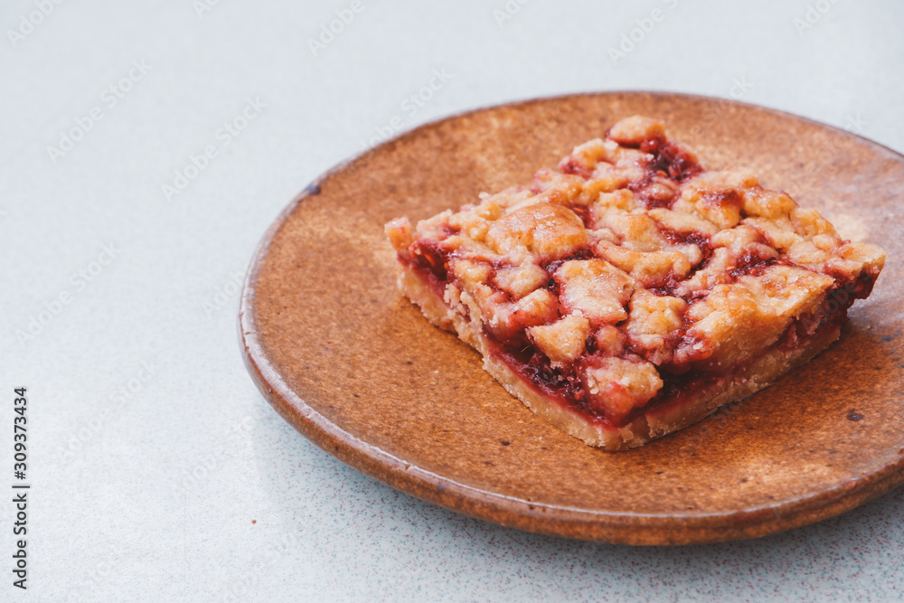 Homemade raspberry crumble bar on plate Homemade raspberry crumble bar on plate
