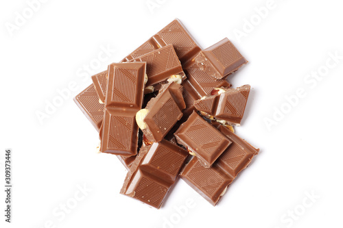 A bar and pieces of milk chocolate isolated on a white background. top view