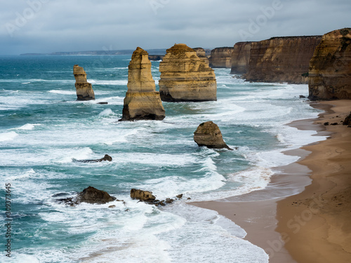 The 12 apostels stands tall as the mighty pacific ocean crashies ashore along the great ocean road melbourne photo