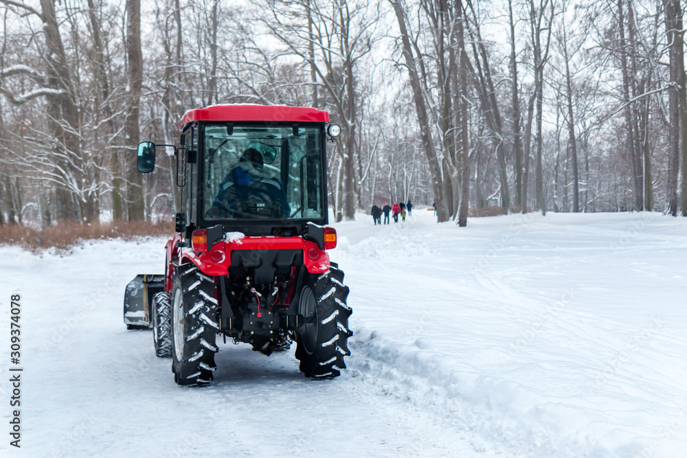snow removal of roads in the park by tractor snow removal of roads in the park by tractor