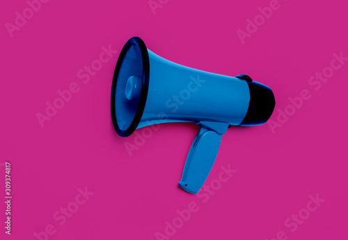 Electronic megaphone on color background