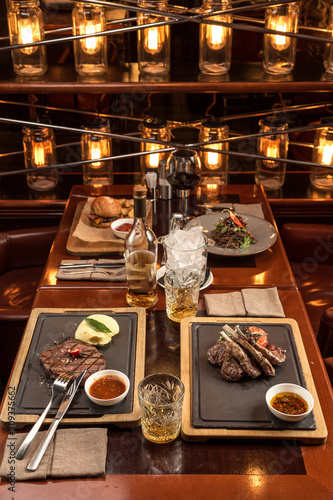 Gourmet meals assorted set on wooden table Buffet at restaurant with light bulbs