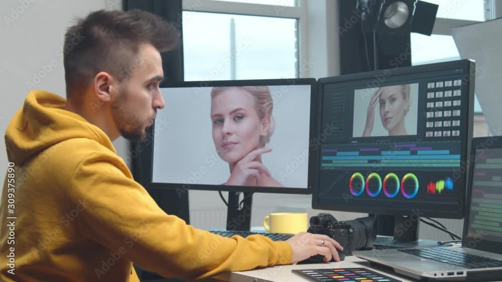 Freelance videographer colorist editing footage using professional
