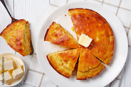 freshly baked Cornbread topped with melted butter photo