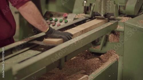 Cooper moving staves into bevel cutter on conveyor belt, medium shot photo