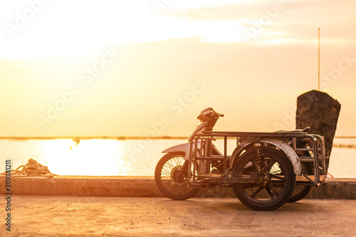  sidecar motorcicle near the sea with sunset. photo