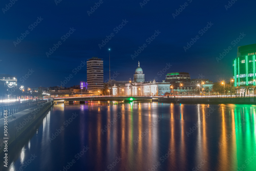 Liffey river with Dublin Custom House at night in Dublin, Ireland.