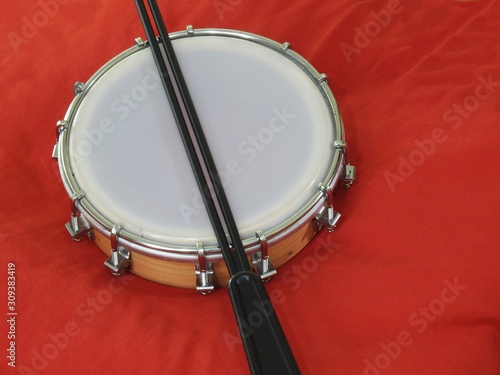 Tamborim and drumstick: a Brazilian percussion musical instrument. It is used to play samba, the famous Brazilian rhythm and has great prominence in the parades of samba schools, in the carnival.