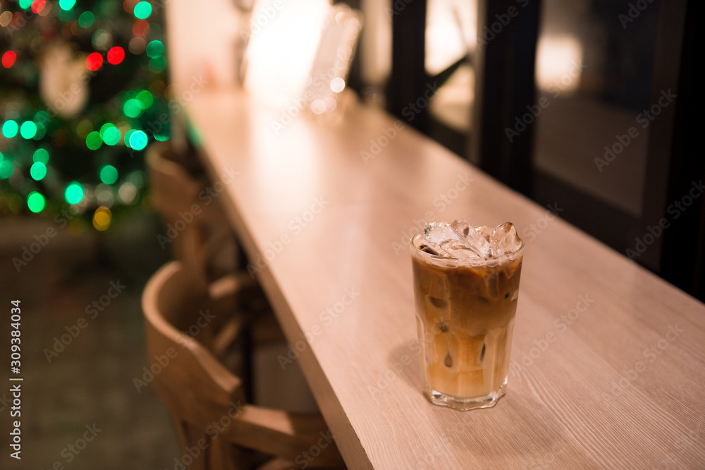 ice latte coffee in plastic cup put on wooden table, christmas theme background