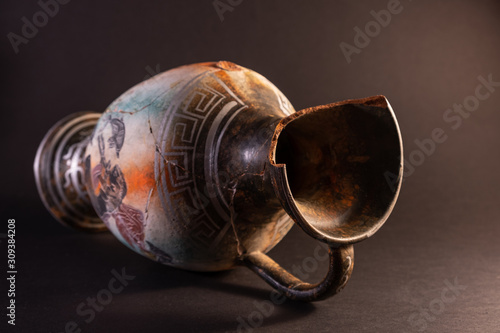 Old broken vase on a dark background