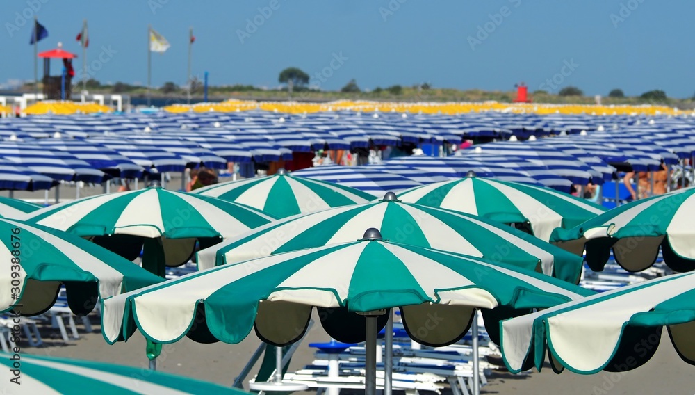 Long rows of umbrellas beach on a mediterranean tourist resort