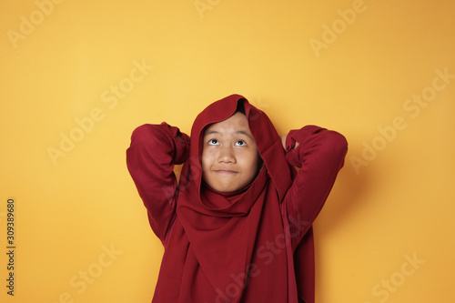 Asian Teenage Muslim Girl Looking Up and Thinking © airdone