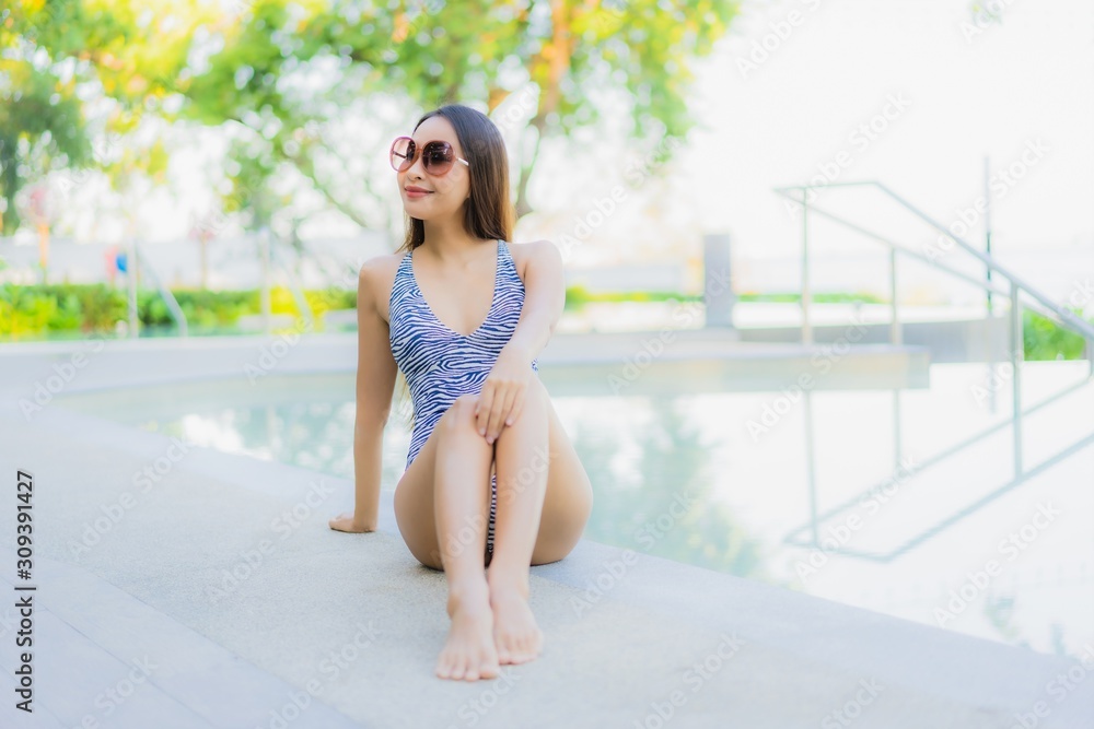 Beautiful young asian women happy smile relax around outdoor swimming pool in hotel resort for travel in holiday vacation