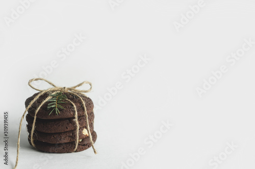 A stack of chocolate cookies on a white background. Beautiful background with a Christmas mood.