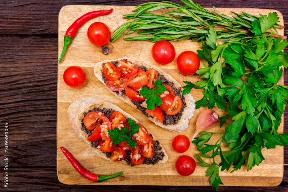 Fresh tasty bruschetta with truffle sauce, parsley and tomates. Top view Fresh tasty bruschetta with truffle sauce, parsley and tomates. Top view